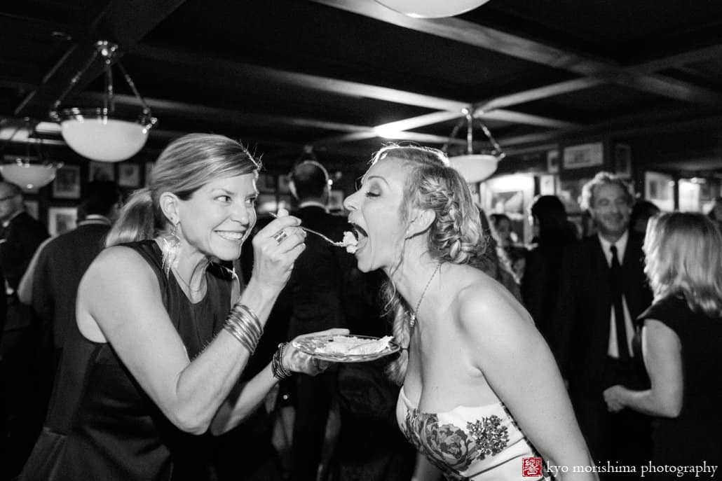 Bride enjoys a piece of cake during Lotos Club wedding after party in The Grill Room, photographed by Kyo Morishima
