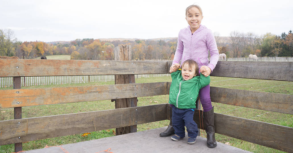 Brother and sister portrait during fall at Readington River Buffalo Farm in Flemington, NJ