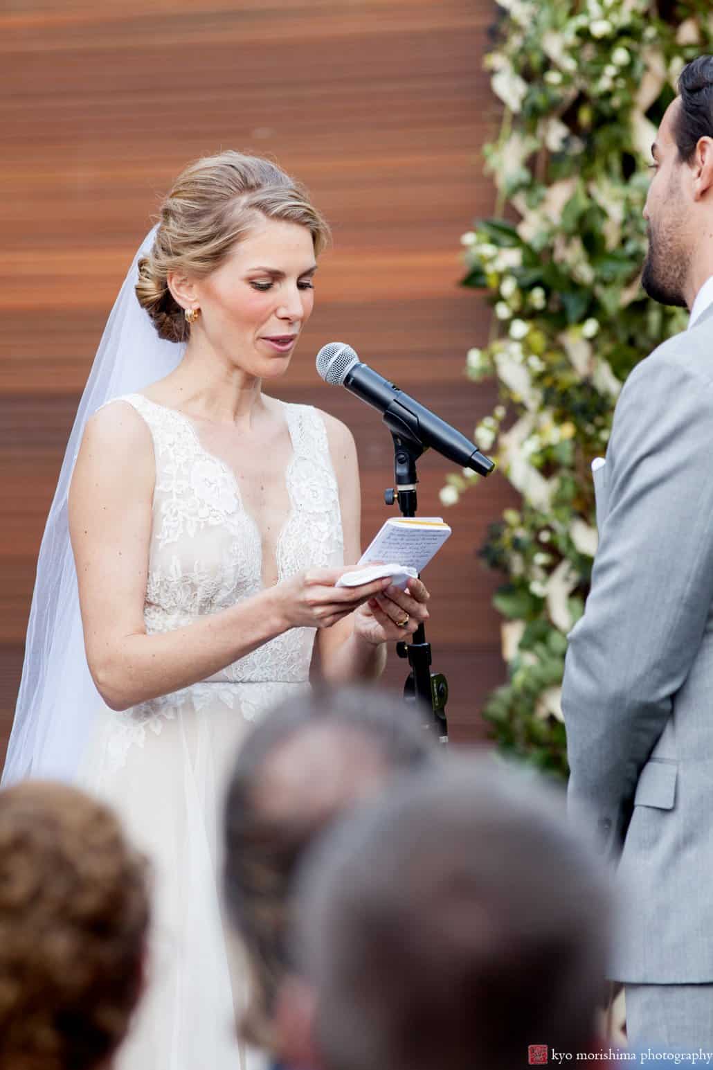 Bride reads vows to groom during Green Building wedding in outdoor courtyard, photographed by Brooklyn wedding photographer Kyo Morishima