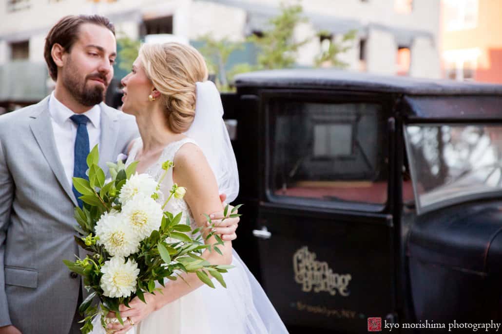 Bride and groom share a tender moment with vintage truck in the background after Green Building wedding in Brooklyn, photographed by Kyo Morishima