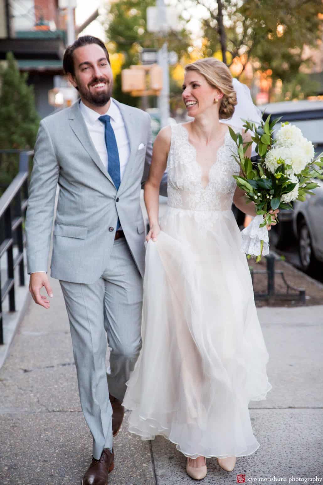 Bride and groom laugh as they walk on Union Street after Green Building Brooklyn wedding ceremony, photographed by Kyo Morishima