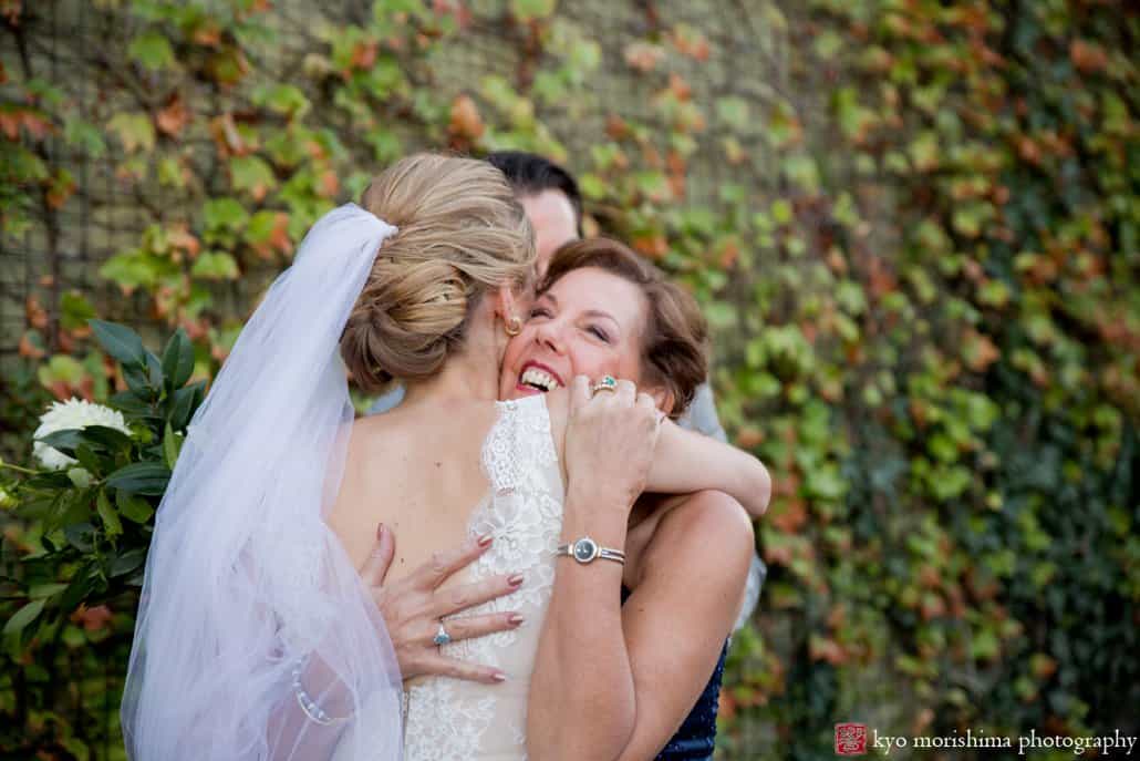 Bride and mother of the groom embrace after Green Building wedding photographed by Kyo Morishima