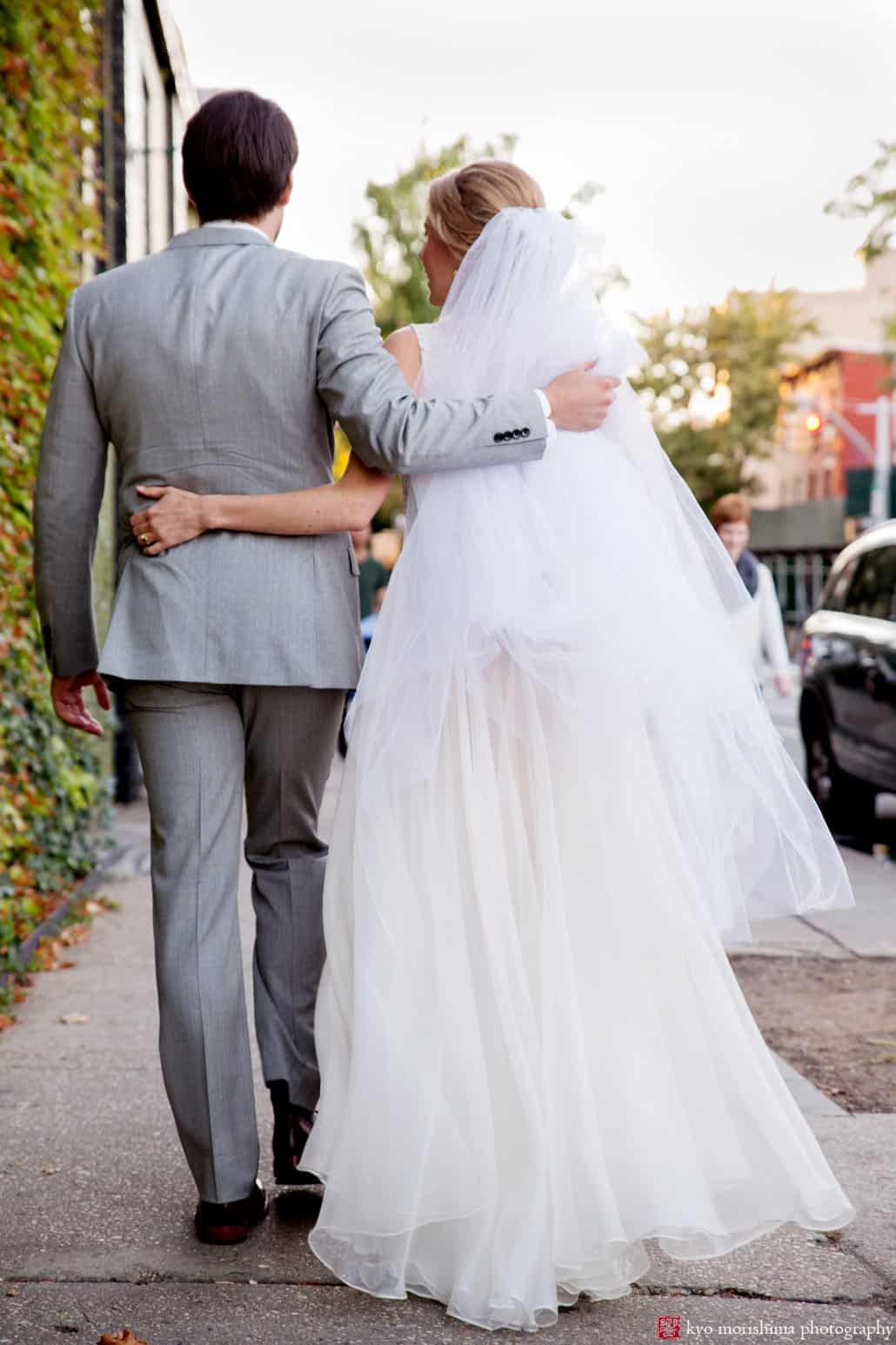 Bride and groom walk down the street in Brooklyn after Green Building wedding photographed by Kyo Morishima