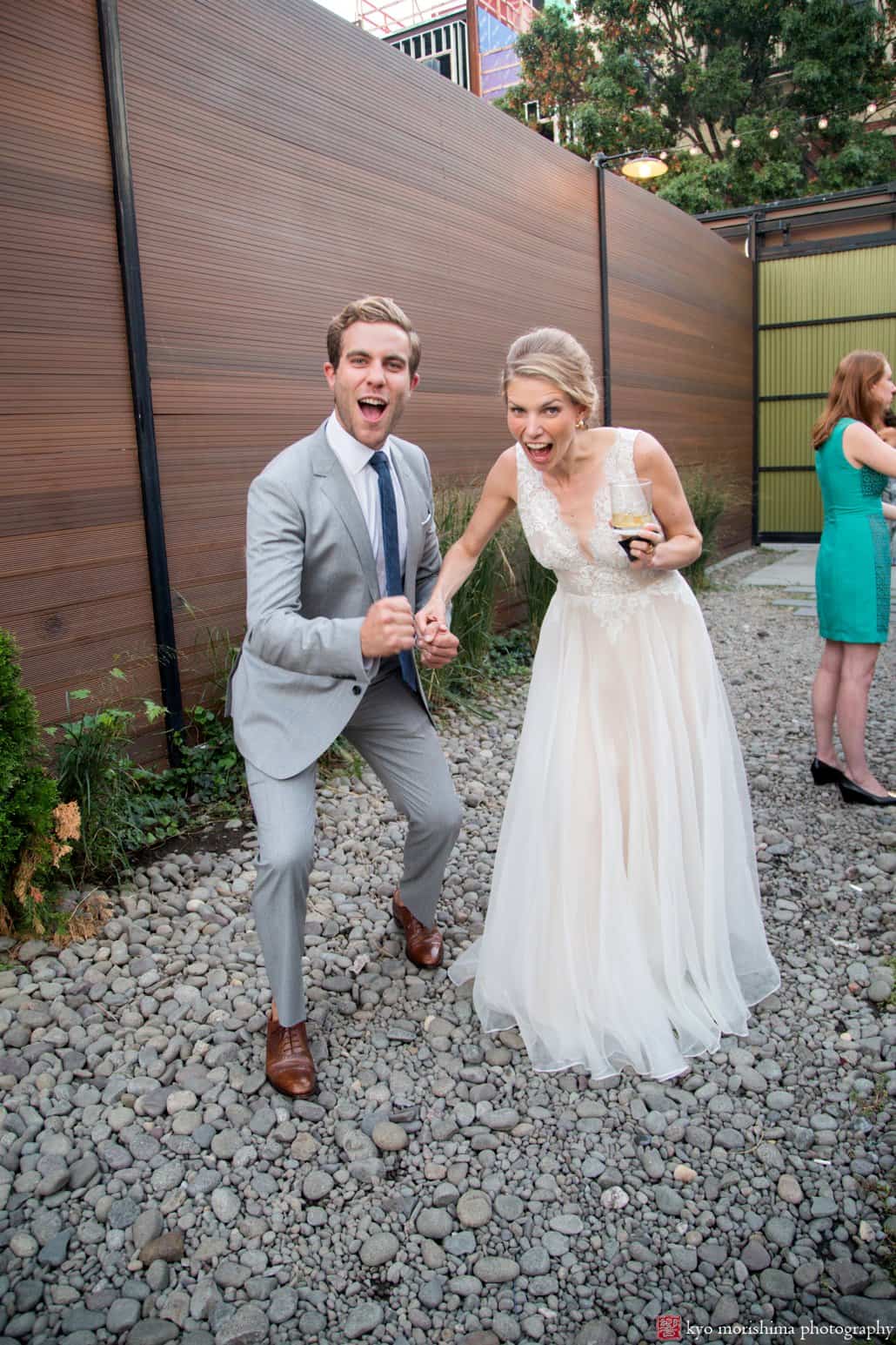 Bride and brother goof off for camera in courtyard at Green Building wedding, photographed by Kyo Morishima
