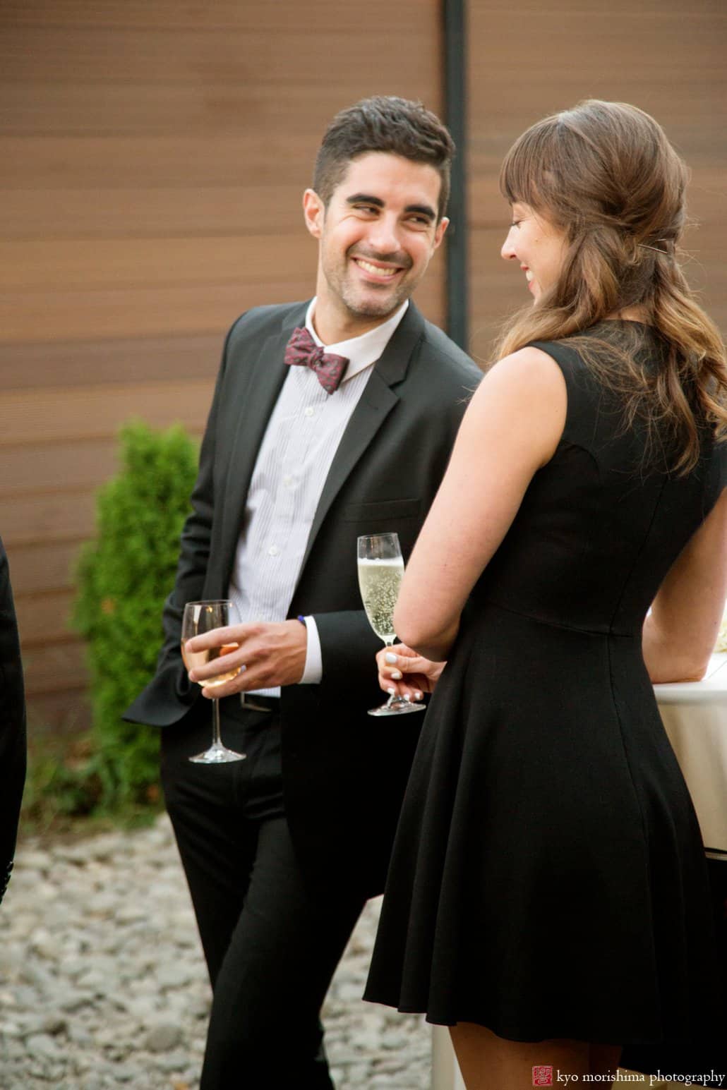 Guests flirt with each other during Green Building wedding cocktail hour, photographed by Kyo Morishima