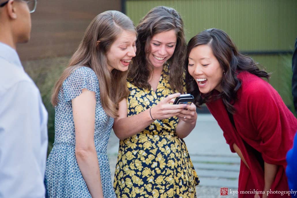 Friends enjoy iphone photos after Green Building wedding, photographed by Kyo Morishima