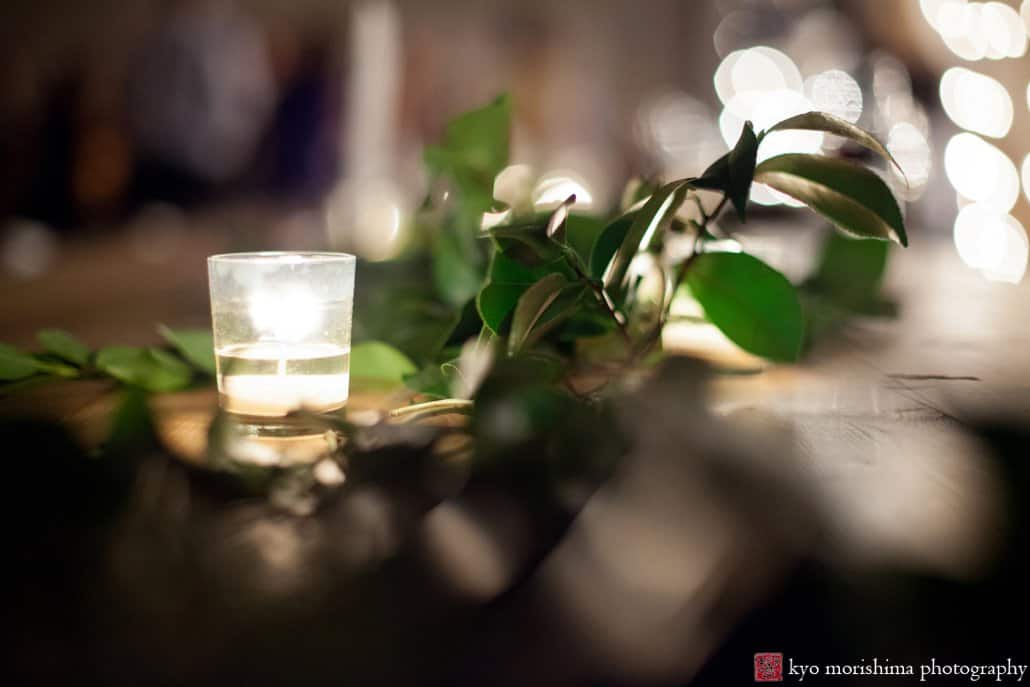 Candle and greenery detail at a wedding in Brooklyn, photographed by Kyo Morishima