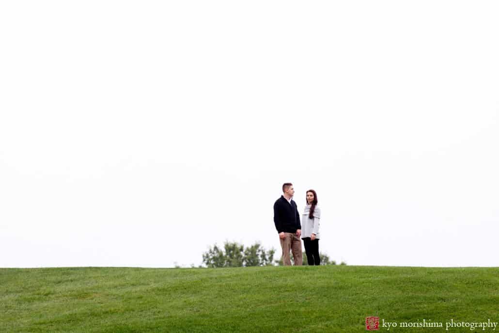 Couple stand on top of a hill during October engagement picture session at Jasna Polana, photographed by Kyo Morishima