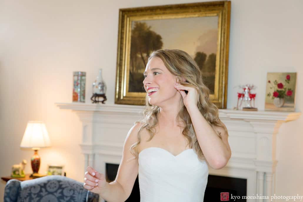 Bride smiles as she glances back at friends after getting ready in her grandparents' home in Princeton