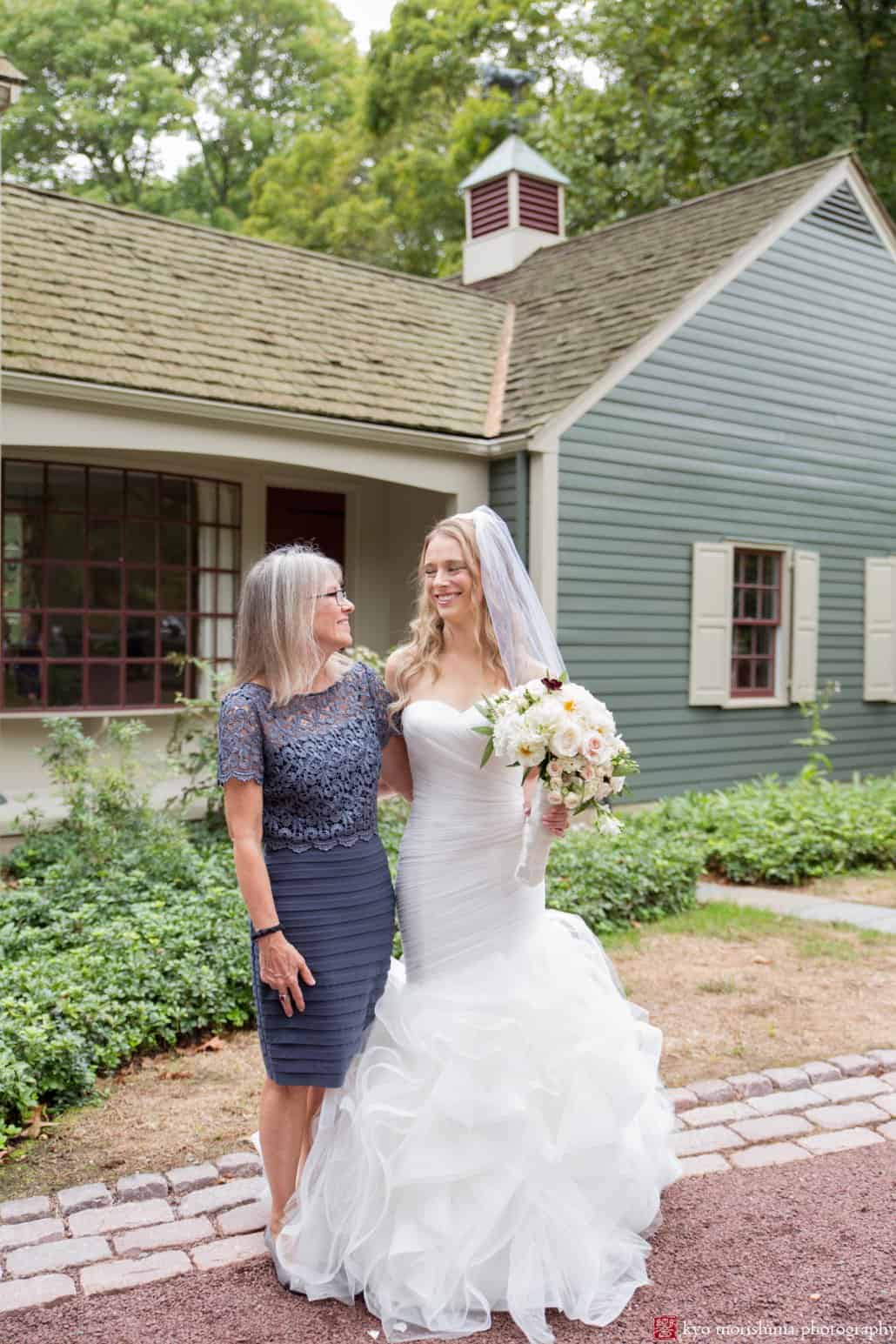 Bride and mother pose for a picture outside grandparents' home before Princeton wedding begins