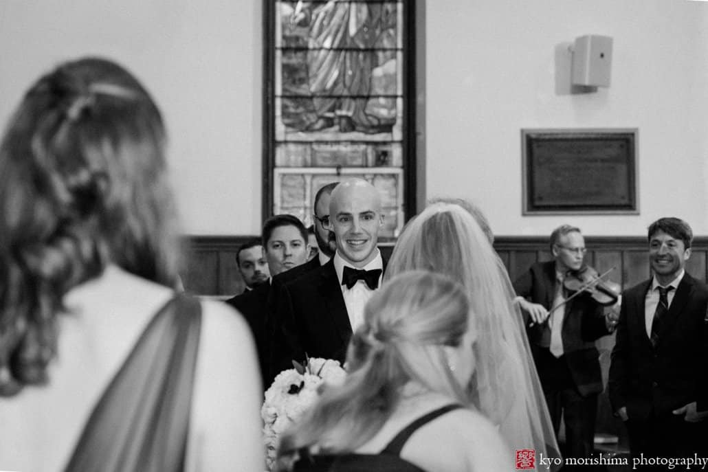 Groom looks at bride as she arrives at alter for Princeton United Methodist Church wedding