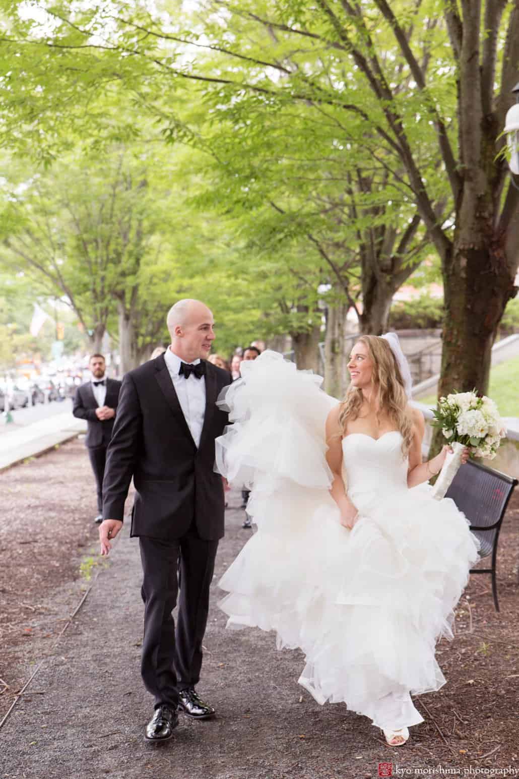 Bride and groom walk down the street for Princeton portrait session