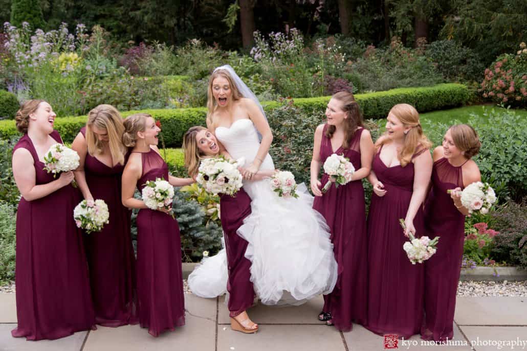 Maid of honor lifts bride for a goofy moment during Prospect Gardens wedding portrait session