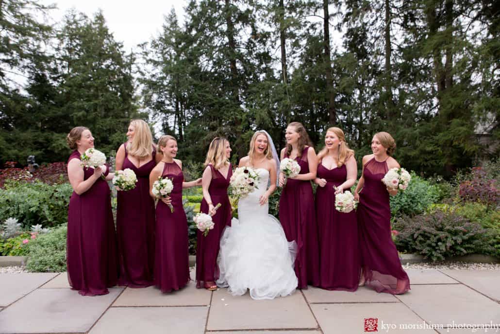 Bride and bridesmaids have fun during Prospect Gardens wedding portrait session in Princeton