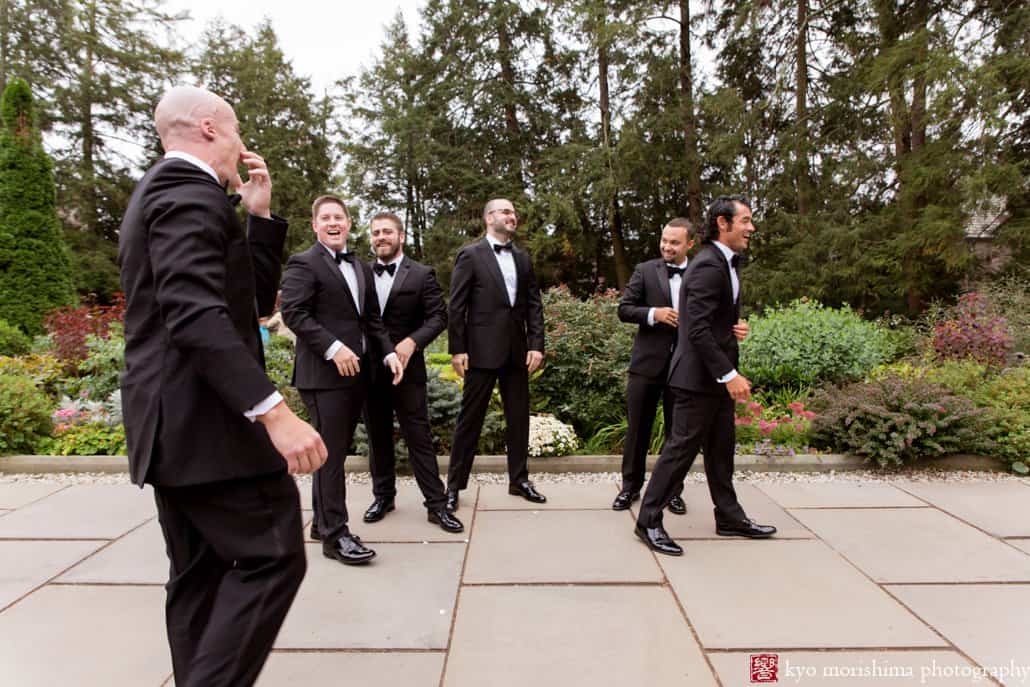 Groom and groomsmen laugh during Prospect Gardens wedding portrait session in October