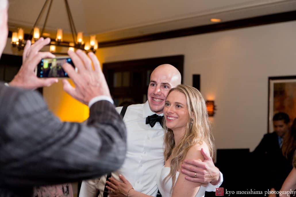 Guest snaps a photo of bride and groom during Cherry Valley Country Club wedding