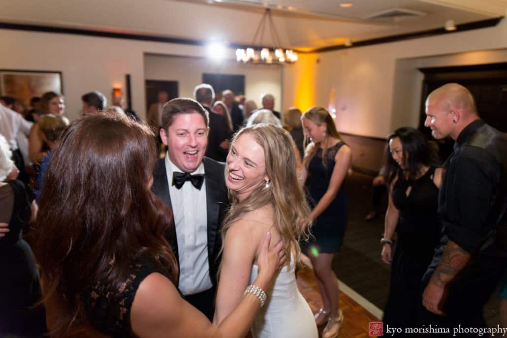 Bride smiles at friends during Cherry Valley Country Club wedding reception