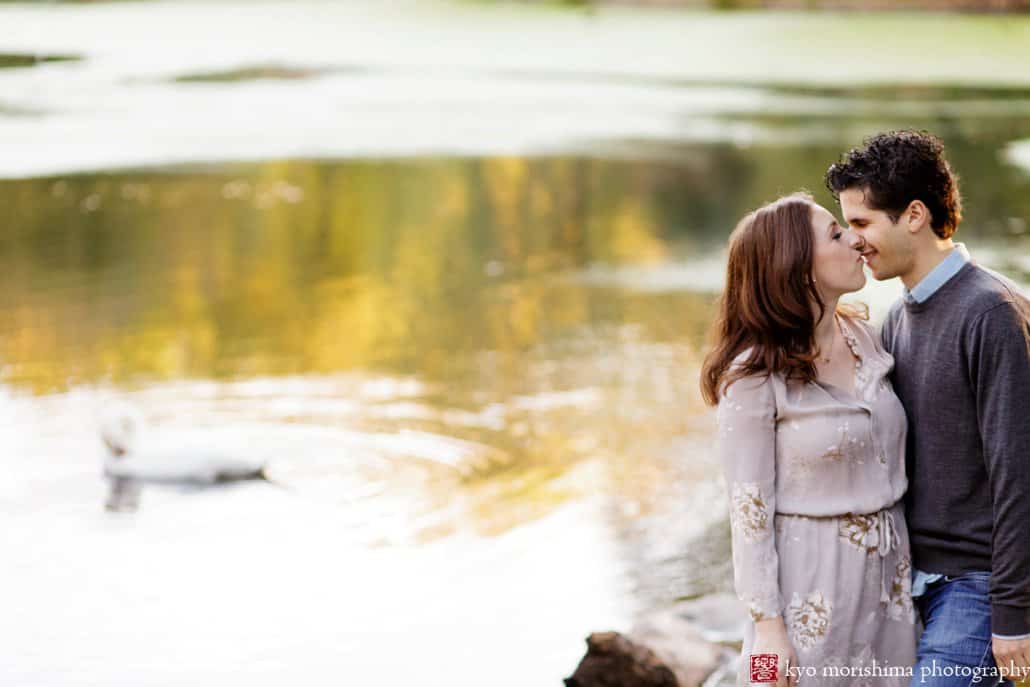 A couple kisses with Prospect Park lake in the background, photographed by Brooklyn wedding photographer Kyo Morishima