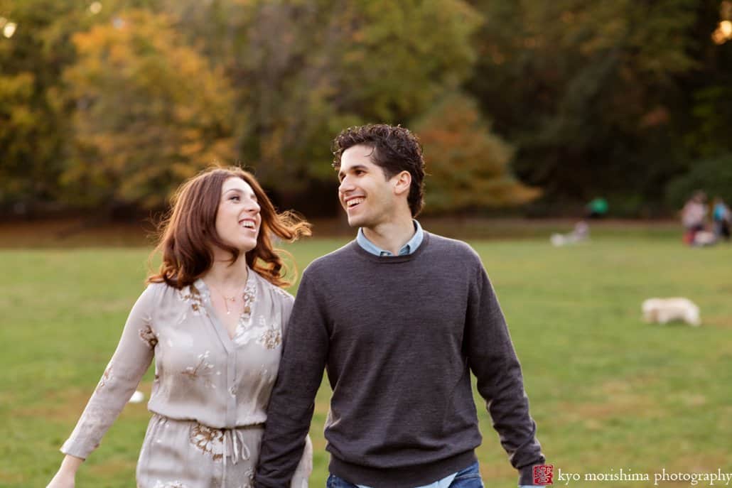 Couple enjoying a walk on the lawn at Prospect Park; engagement picture photographed by Kyo Morishima