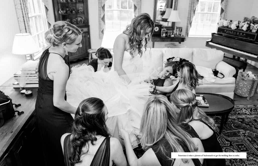 Bride gets ready in the living room, surrounded by a posse of bridesmaids helping with her Pronovias wedding dress