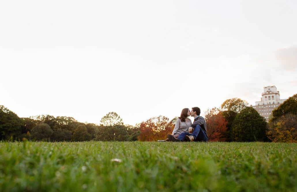 Prospect Park sunset engagement picture with couple kissing in the midground