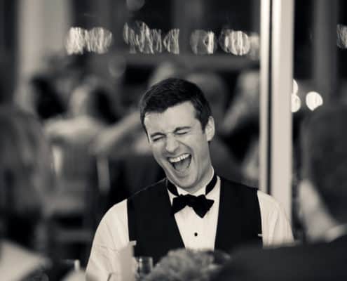 Groom laughing at Battery Garden Wedding Reception, NYC