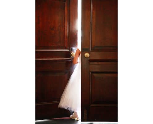 flower girl standing by a door way of Unitarian Church NYC