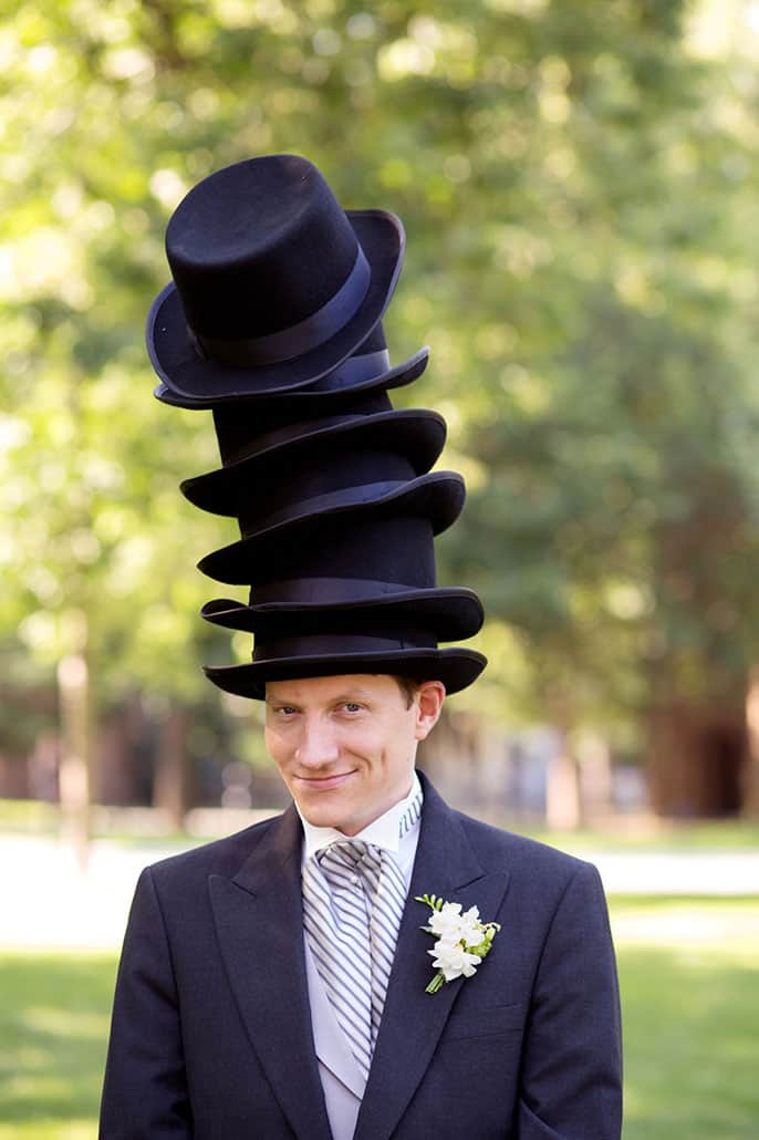 Funny groom's portrait at Princeton spring wedding; he wears six black bowler hats. photographed by Kyo Morishima