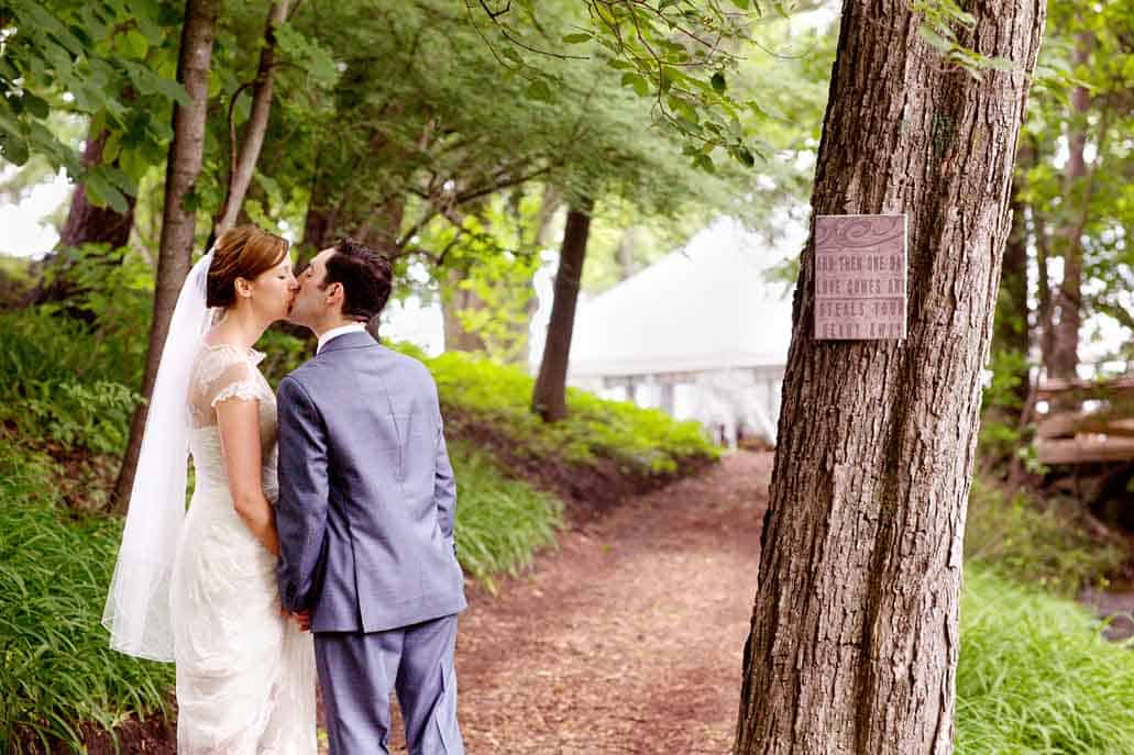 Lake Geneva rustic backyard wedding portrait with sign saying "And then one day love comes and steals your heart away".