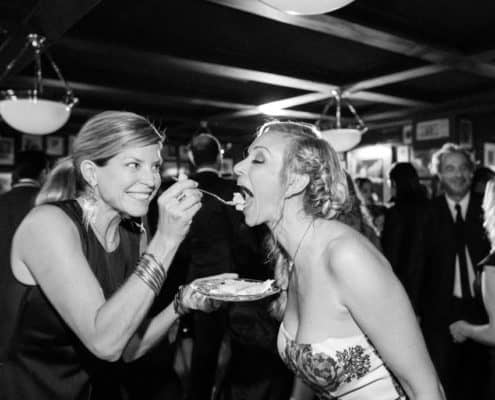 girlfriend feeds bride cake