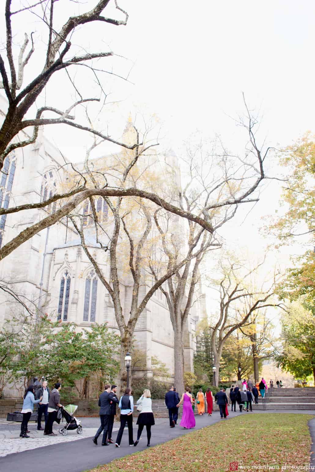 Wedding guests walk toward Princeton University Chapel for October wedding