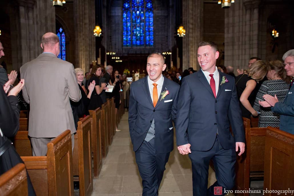 Same sex couple smile as they depart wedding ceremony at Princeton University Chapel