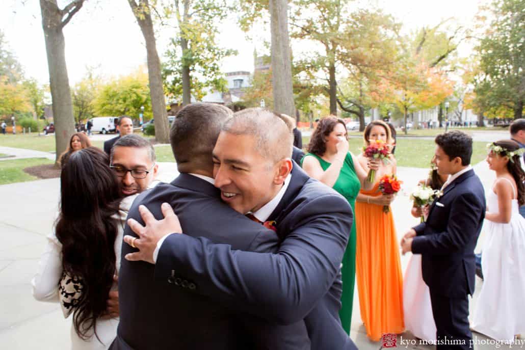 Groom embraces family member after Princeton University Chapel wedding in October