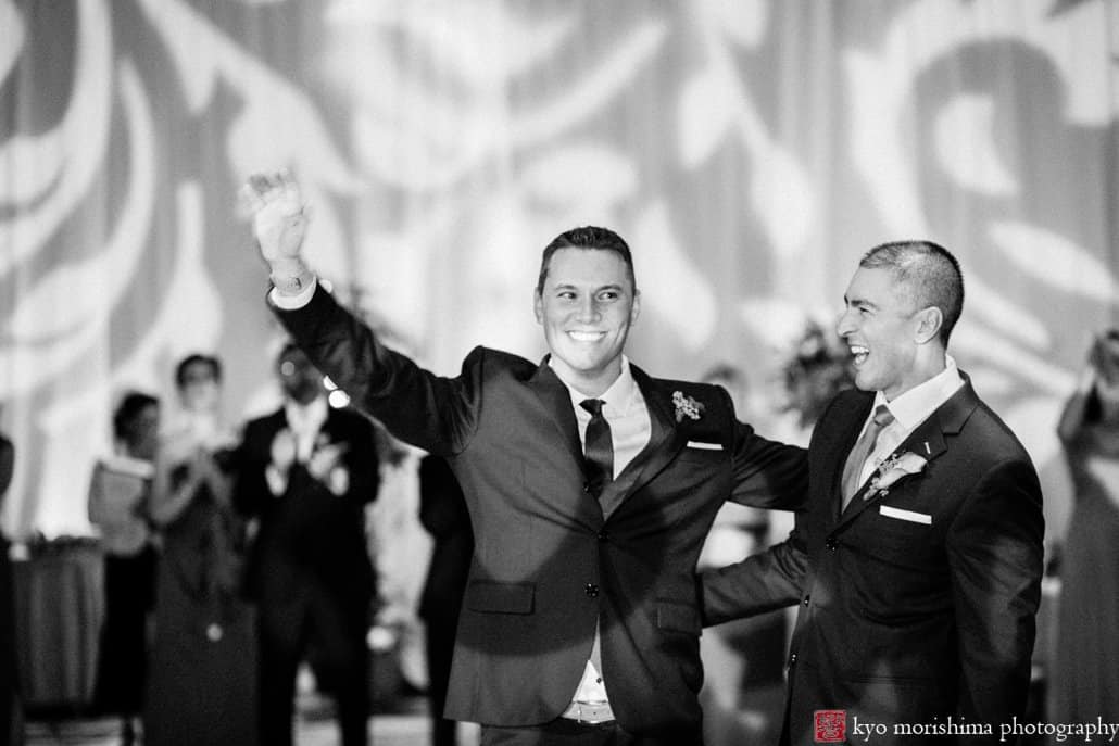 Grooms greet guests as first dance begins at Hyatt Regency Princeton same sex wedding reception