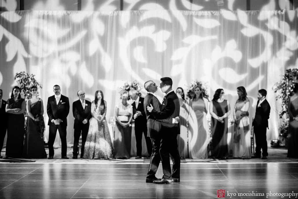 First dance at Hyatt Regency Princeton same sex wedding reception with dramatic uplighting by JBL Lighting Design