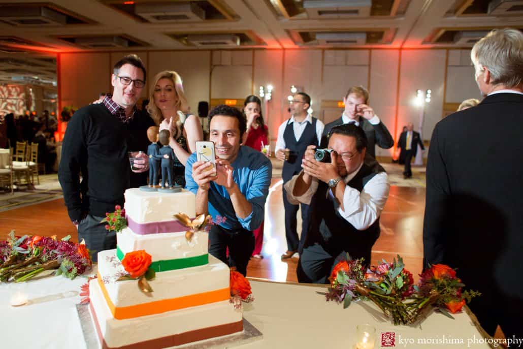 Guests photograph bobblehead wedding cake toppers at Hyatt Regency Princeton wedding reception