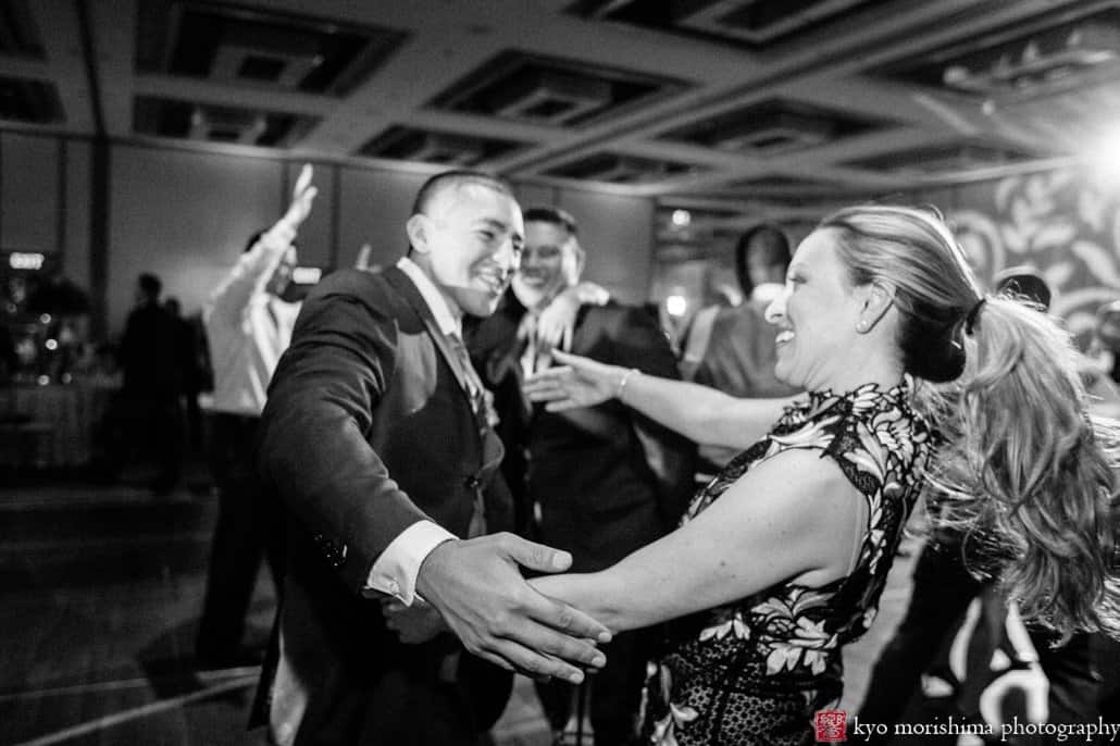 Groom embraces friend at Hyatt Regency Princeton wedding reception