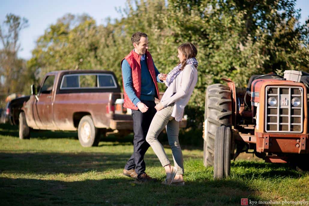 A couple laughs during engagement session at one of NJ's best outdoor photography spots: Terhune Orchards in Princeton.