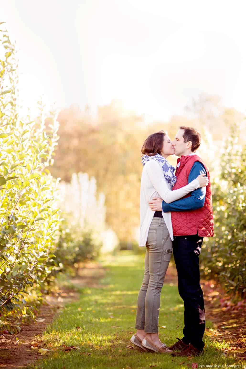 A kiss at Terhune Orchards, photographed on a brisk fall day by NJ engagement photographer Kyo Morishima