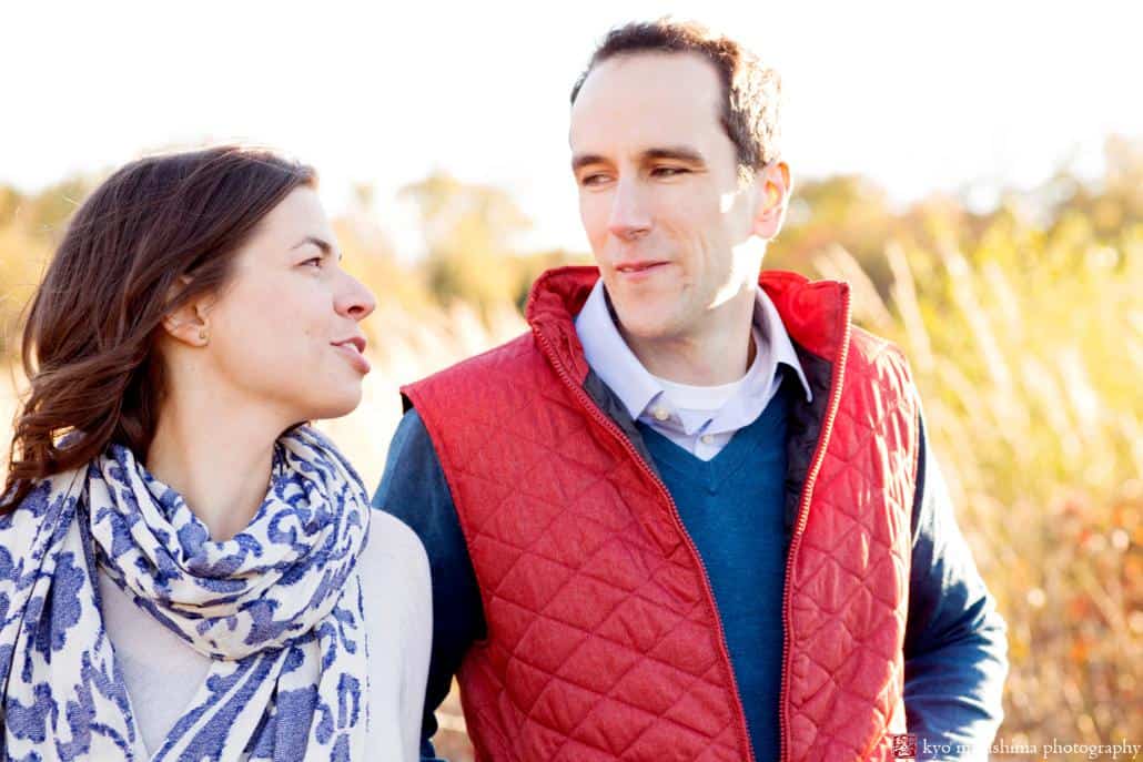 Fall engagement picture tinged with golden hour sunlight, photographed at Terhune Orchards in Princeton, NJ