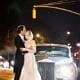 Bride and groom in front of 1963 Rolls Royce on 5th Ave, NYC after a wedding reception and rain. Allure Couture