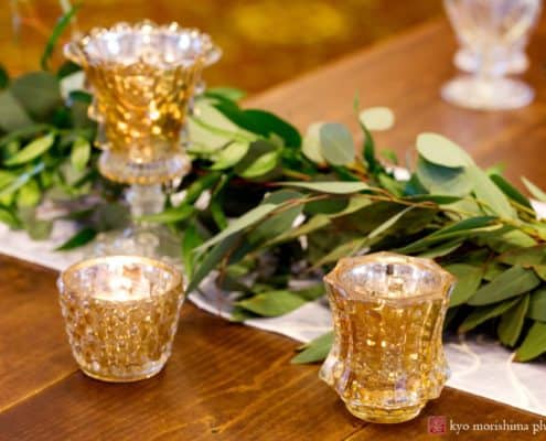 Italian ruscus greenery wedding decor with gold tea candle receptacles at the Nassau Inn's Princeton wedding show