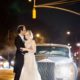 Bride and groom embrace in front of a 1955 Rolls Royce for an evening wedding photo in NYC at the Lotos Club. Lotos Club Wedding Photography by Kyo Morishima. Allure Couture wedding gown.