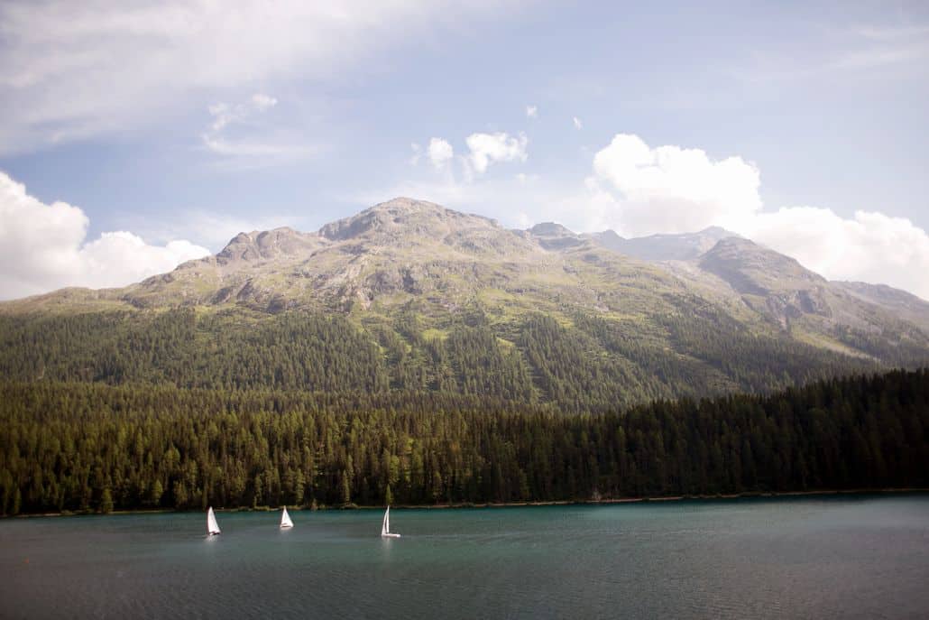 Lake St. Moritz in Switzerland, three sailboats, tree lined Swiss Alps, European destination wedding photography,