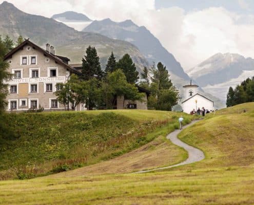 Hotel Sonne, Switzerland European destination wedding, winding road, grassy hills, Swiss Alps.