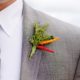 green foliage with red and orange pepper boutineer on gray suit, Dahlias Florist, Spring Lake NJ wedding photographer.