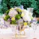 blue green and yellow wedding centerpiece with sea holly, hydrangea, roses, wooden chairs, white linens, clear candleholders and stemware, green foliage backdrop, Dahlia's Florist, Spring Lake NY wedding photographer.