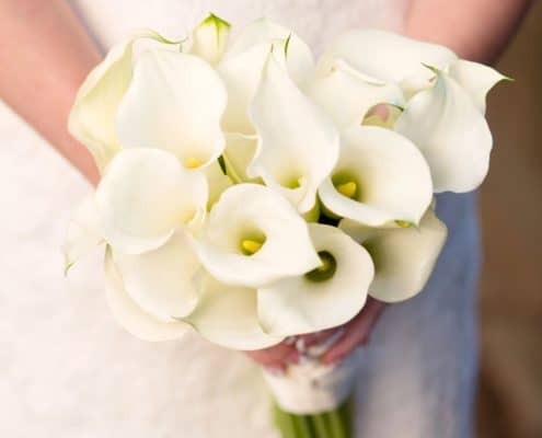 white calla lily bridal bouquet held by bride in lace gown, Polka Dot events, Central Park NYC wedding photographer.
