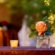 Peach rose in bud vase for wedding table decor, mercury glass tea light holder, burnt orange crushed silk tablecloth, dark wood chairs, Kristin Rockhill florist, Nassau Inn, Princeton, NJ wedding photographer.