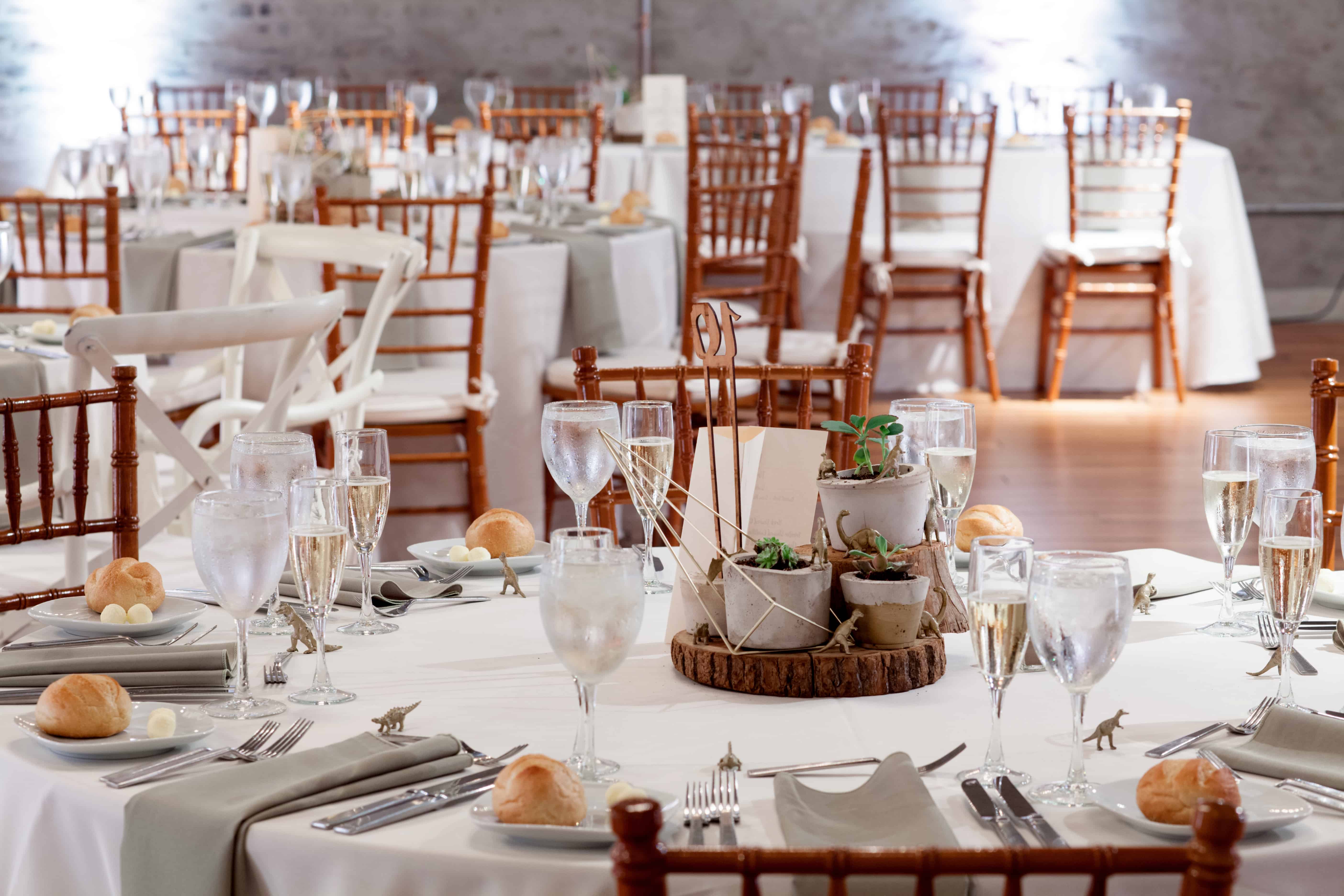 wedding table settings with white tablecloths, wooden tiered centerpiece, succulents in hypertufa pots, taupe napkins, bread and butter plates, wooden chiavari chairs, Front and Palmer, Philadelphia, PA wedding photographer, DIY wedding flowers.